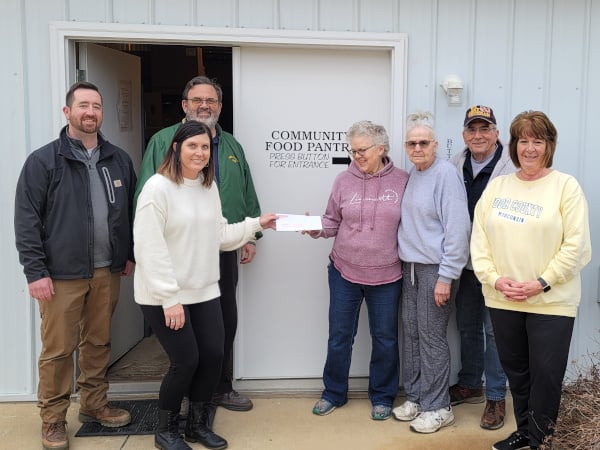 Energy MFG Controller giving a check to the Monticello Community Food Back